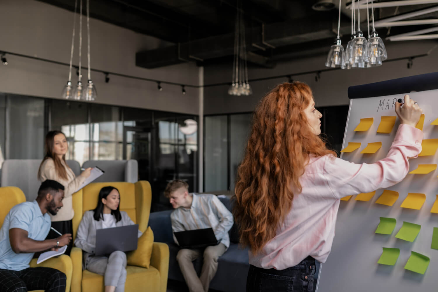 A woman standing in front of a whiteboard.