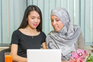 Asian and muslim girls working on a laptop