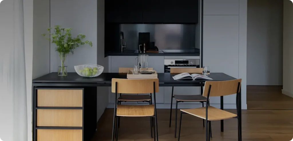 Modern kitchen with dining table and chairs.