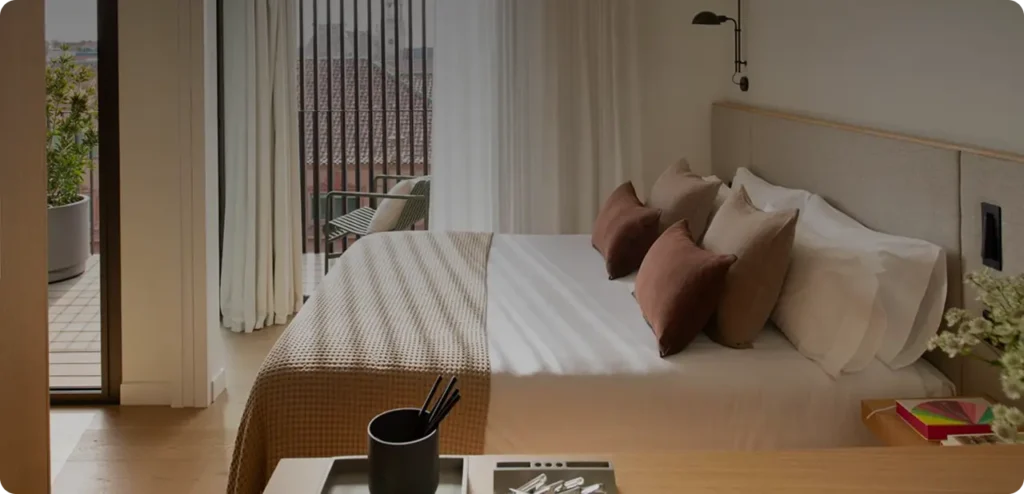 Hotel room with bed and balcony view.