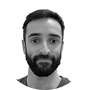 Here's an alt tag for the image: `Headshot of a man with a beard`