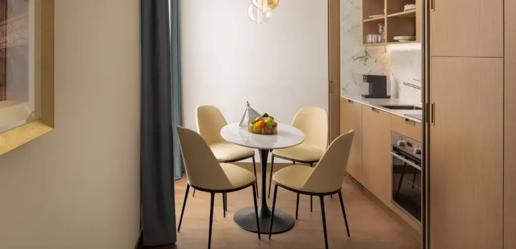 Modern kitchen with round table and chairs.