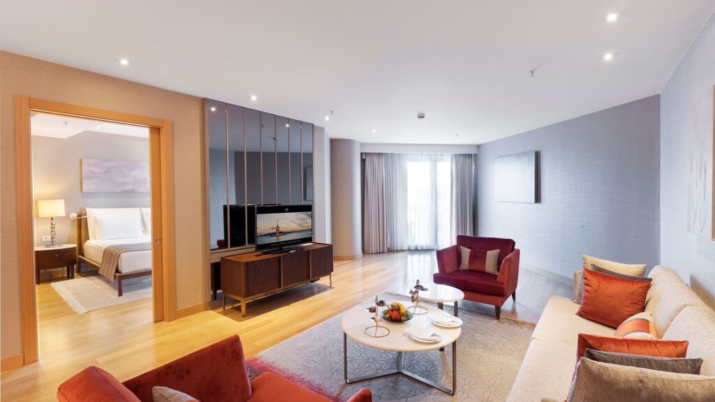 Modern hotel suite with cozy seating area.