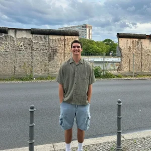 Person standing in front of wall ruins.