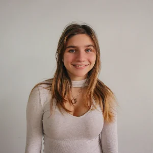 Go to market strategy for fintech startup (1) (1) A young woman in white shirt and necklace.