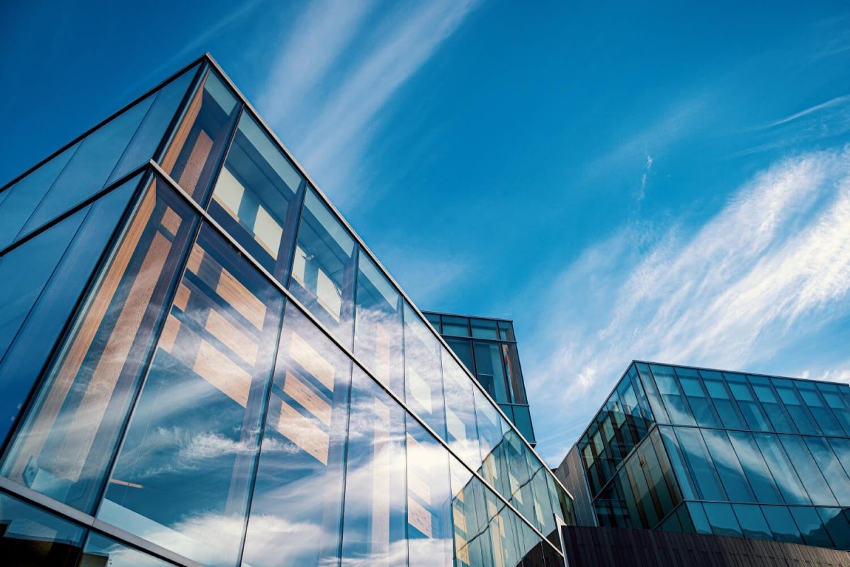 A building with many windows and some clouds in the sky