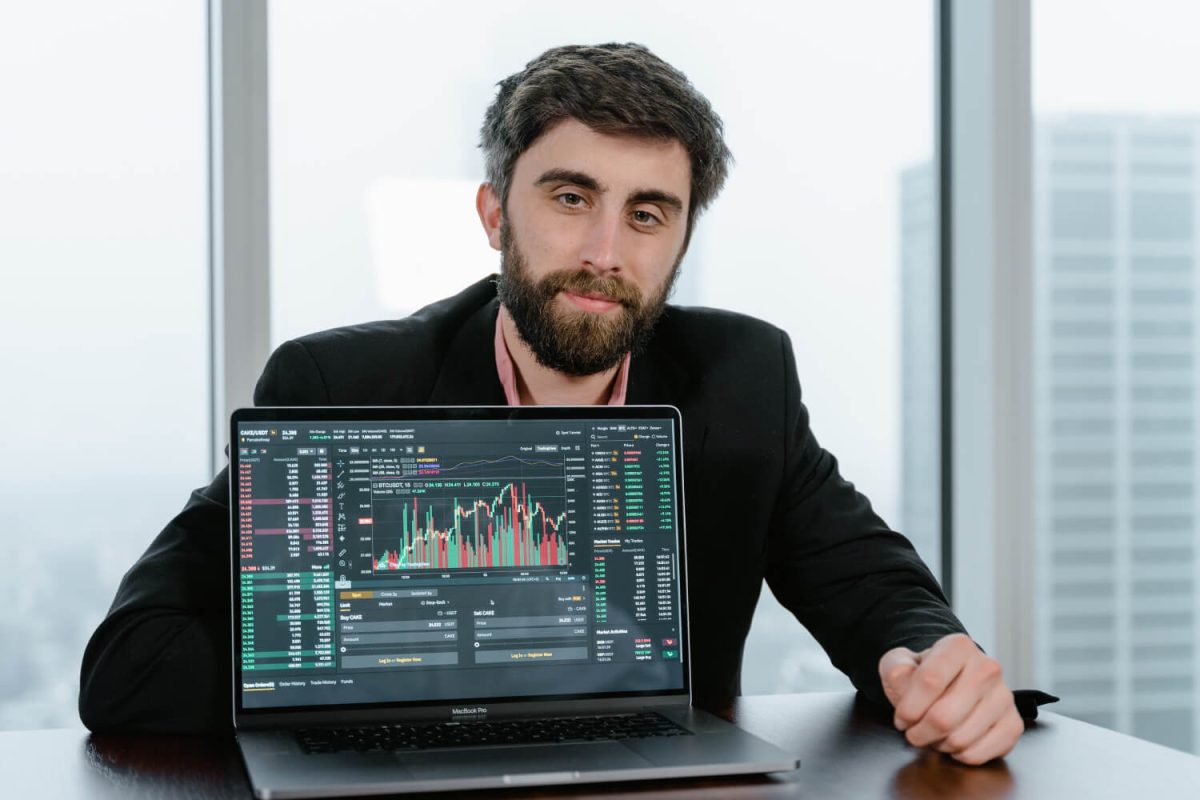 A man sitting at a table with a laptop.